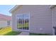 Backyard patio with sliding glass door leading to grassy lawn and siding at 4928 Silverdene St, Raleigh, NC 27616