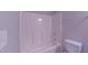 Full bathtub and shower combination in a modern bathroom with a shower caddy at 4928 Silverdene St, Raleigh, NC 27616