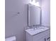 Bathroom vanity with a stone countertop, modern mirror and fixtures at 4928 Silverdene St, Raleigh, NC 27616