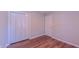 A bedroom offers ample storage with a large closet and wood-look floors at 4928 Silverdene St, Raleigh, NC 27616