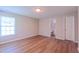 Well-lit bedroom featuring luxury vinyl plank flooring, a window, and access to a bathroom and closet at 4928 Silverdene St, Raleigh, NC 27616
