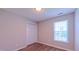 Bedroom featuring closet, wood-look flooring and a window for natural light at 4928 Silverdene St, Raleigh, NC 27616
