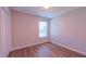 Bedroom featuring closet, wood-look flooring and a window for natural light at 4928 Silverdene St, Raleigh, NC 27616