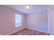 Bedroom featuring luxury vinyl plank flooring, a window, and a closet at 4928 Silverdene St, Raleigh, NC 27616