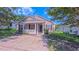 Inviting home exterior featuring a covered porch, black shutters, and manicured landscaping at 4928 Silverdene St, Raleigh, NC 27616