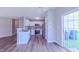 A well-lit kitchen with stainless steel appliances and white cabinets, seamlessly blending with the dining area at 4928 Silverdene St, Raleigh, NC 27616