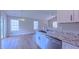 Open-concept kitchen with stainless steel appliances, granite countertops, and bright, natural light at 4928 Silverdene St, Raleigh, NC 27616
