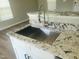Modern kitchen sink with granite countertops and a stainless steel faucet with pull-down sprayer at 4928 Silverdene St, Raleigh, NC 27616