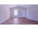 Bright, open living space showcasing wood-look floors, vaulted ceiling, and neutral paint at 4928 Silverdene St, Raleigh, NC 27616