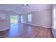 Bright living room featuring wood-look floors, lots of natural light and a slider to the backyard at 4928 Silverdene St, Raleigh, NC 27616