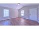 Bright living room features vaulted ceilings, modern ceiling fan, and durable wood-look floors at 4928 Silverdene St, Raleigh, NC 27616