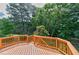 A wooden back deck overlooks the lush green foliage of mature trees and landscaping at 500 Walcott Way, Cary, NC 27519