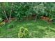 Expansive backyard with a lush lawn, mature trees, and a wood fence at 500 Walcott Way, Cary, NC 27519