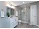 Charming bathroom with white marble-tile shower, updated vanity, and wood-look floors at 500 Walcott Way, Cary, NC 27519
