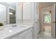 Bathroom with white countertops and cabinets with decorative items and great lighting at 500 Walcott Way, Cary, NC 27519
