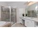 Elegant bathroom featuring a glass shower, a soaking tub, and a vanity with great lighting at 500 Walcott Way, Cary, NC 27519