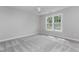 A spacious bedroom with neutral carpet, lots of natural light and a ceiling fan at 500 Walcott Way, Cary, NC 27519