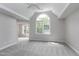 Spacious bedroom with a ceiling fan, a large window, and plush carpet at 500 Walcott Way, Cary, NC 27519