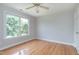 A bright bedroom with hardwood floors and a large window offering lots of natural light at 500 Walcott Way, Cary, NC 27519