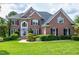 Beautiful two-story brick home with manicured lawn and lush landscaping at 500 Walcott Way, Cary, NC 27519