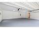 Spacious two-car garage featuring an automatic door opener, gray floors, and neutral walls at 500 Walcott Way, Cary, NC 27519