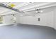 Spacious two-car garage featuring an automatic door opener and neutral painted walls at 500 Walcott Way, Cary, NC 27519