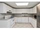 Bright kitchen with white cabinets, granite countertops, and stainless steel refrigerator at 500 Walcott Way, Cary, NC 27519