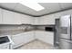 Bright kitchen with white cabinets, granite countertops, and stainless steel appliances at 500 Walcott Way, Cary, NC 27519
