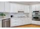 Bright kitchen features stainless steel appliances, white cabinets, and hardwood floors at 500 Walcott Way, Cary, NC 27519