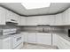 Bright kitchen with white cabinets, granite countertops, and modern appliances at 500 Walcott Way, Cary, NC 27519