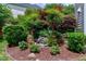 Landscaping with a rock water feature, mulch, and shrubs at 500 Walcott Way, Cary, NC 27519