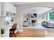 Open-concept living room with a fireplace, built-in shelving, and a desk area at 500 Walcott Way, Cary, NC 27519