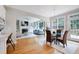 Open-concept living room connected to dining area, featuring a fireplace and built-in shelving at 500 Walcott Way, Cary, NC 27519