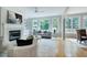 Comfortable living room with fireplace, large windows, and hardwood floors at 500 Walcott Way, Cary, NC 27519