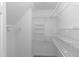 A functional walk-in closet with white shelving at 500 Walcott Way, Cary, NC 27519