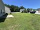 Expansive back yard with plenty of green space and rear view of neighboring homes at 5819 Finestra Way, Raleigh, NC 27610