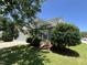 Well landscaped front yard with an eye-level, partially obstructed view of the home at 5819 Finestra Way, Raleigh, NC 27610