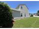 Side yard with well-maintained lawn, window views, and exterior vinyl siding at 5819 Finestra Way, Raleigh, NC 27610