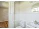 This bathroom features a pristine white toilet and sink with a round mirror at 605 Sagefield Way, Henderson, NC 27537