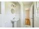All-white bathroom features a pedestal sink and tiled walls at 605 Sagefield Way, Henderson, NC 27537