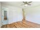 Bedroom with hardwood floors, ceiling fan, closet and view to the bathroom at 605 Sagefield Way, Henderson, NC 27537