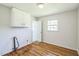 Bright bedroom features hardwood floors, fresh paint, and a large window for natural light at 605 Sagefield Way, Henderson, NC 27537