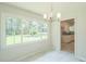 Bright dining room features large picture window overlooking the backyard at 605 Sagefield Way, Henderson, NC 27537