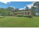 Brick house, showcasing manicured front lawn and tidy garden at 605 Sagefield Way, Henderson, NC 27537