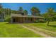 Exterior view of brick home, featuring a covered side porch and a long driveway at 605 Sagefield Way, Henderson, NC 27537