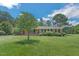Inviting front view of brick home, highlighting the well-maintained lawn and shade tree at 605 Sagefield Way, Henderson, NC 27537