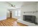 Living room features a white brick fireplace with hardwood floors and lots of light at 605 Sagefield Way, Henderson, NC 27537