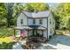 Beautiful aerial view of a two-story home with a metal roof and a covered front porch at 605 W Holt St, Mebane, NC 27302