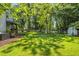 A spacious and well-maintained yard featuring a shed, chicken coop and wooden fence at 605 W Holt St, Mebane, NC 27302