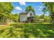 Well-manicured backyard with green lawn, storage shed and wooden fence at 605 W Holt St, Mebane, NC 27302